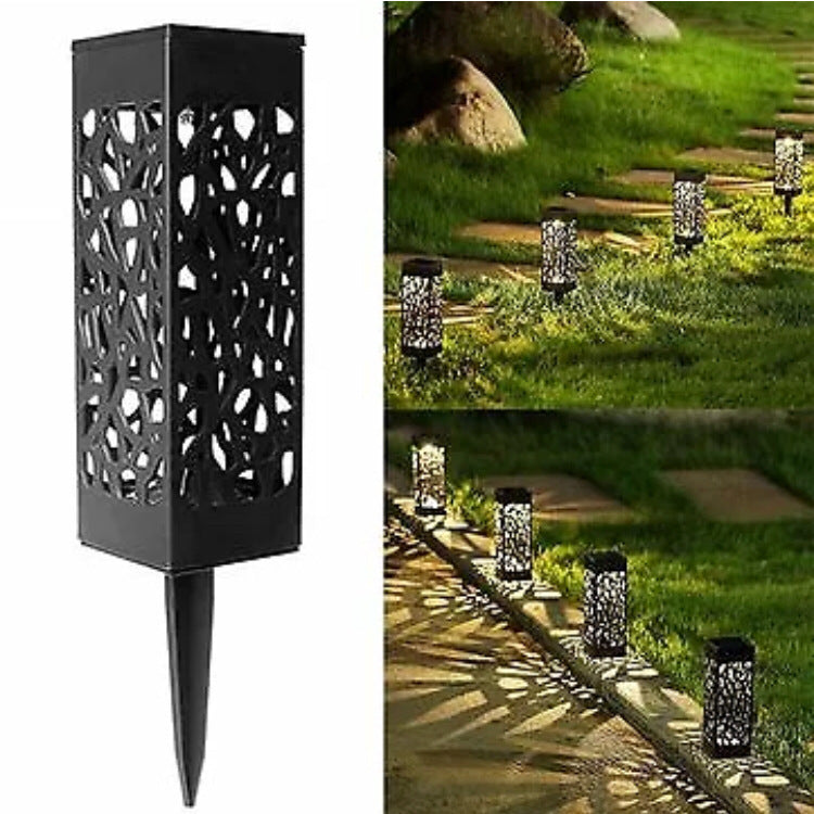 Black garden lantern light with decorative cut-out design, shown in outdoor setting.