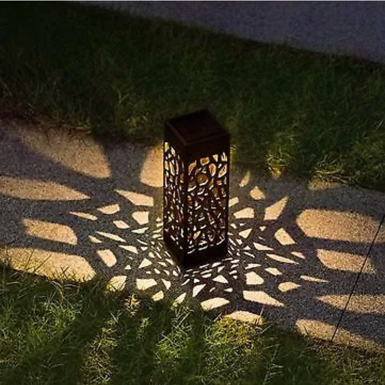 Solar-powered outdoor lamp casting a pattern on the ground