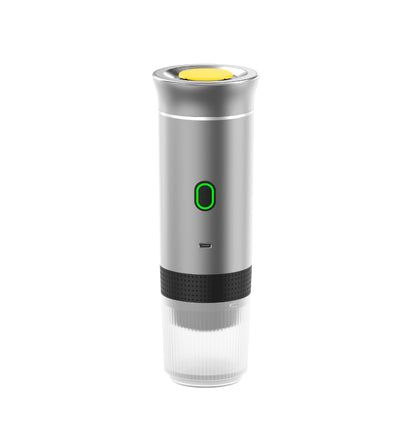 Silver portable coffee maker with a yellow top and green light on a white background