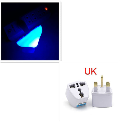 Travel adapter with blue mushroom shaped night light and UK plug adapter on a white background