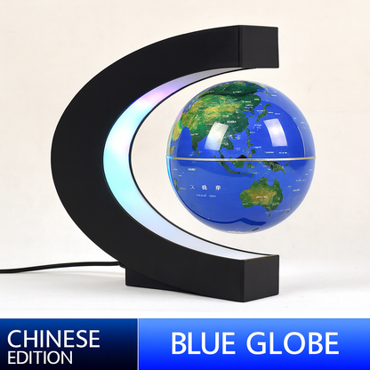 Blue globe with LED lighting on a black stand against a white background