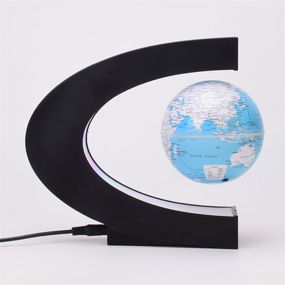 light blue globe with black curved stand on a white background
