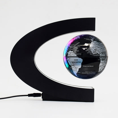 black and silver levitating globe with black base and white background