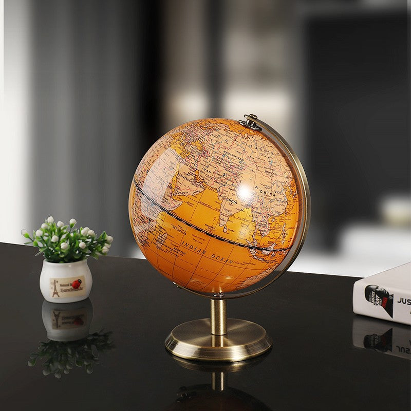 World globe on a dark surface with a blurred background