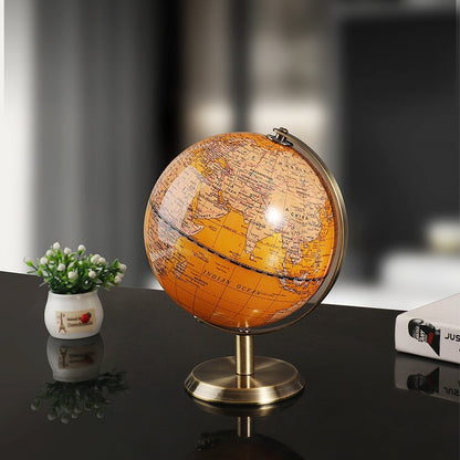 World globe on a dark surface with a blurred background