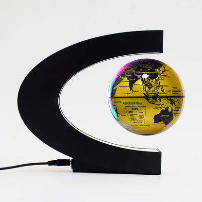 Gold globe with black curved stand on a white background