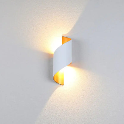 Modern wall light fixture on a textured white wall