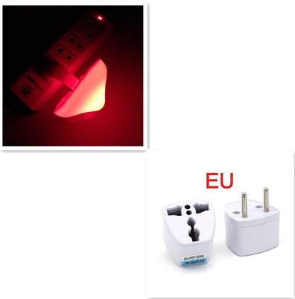 Two travel adapters and a red mushroom shaped night light on a black background.