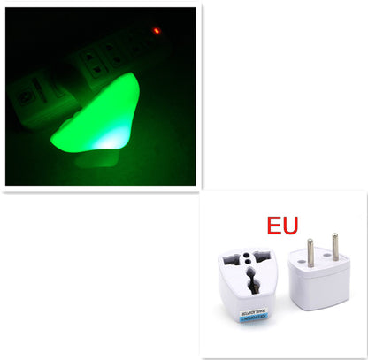 Green mushroom shaped night light and two white travel adapters with 'EU' label on a white background