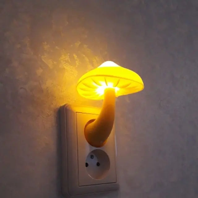 Mushroom-shaped night light plugged into a wall socket with a warm glow.