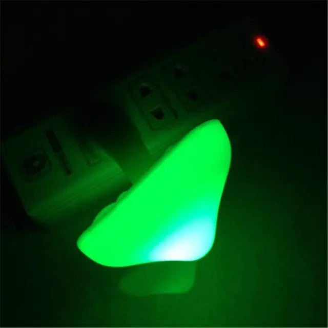 Green glowing object against a dark background